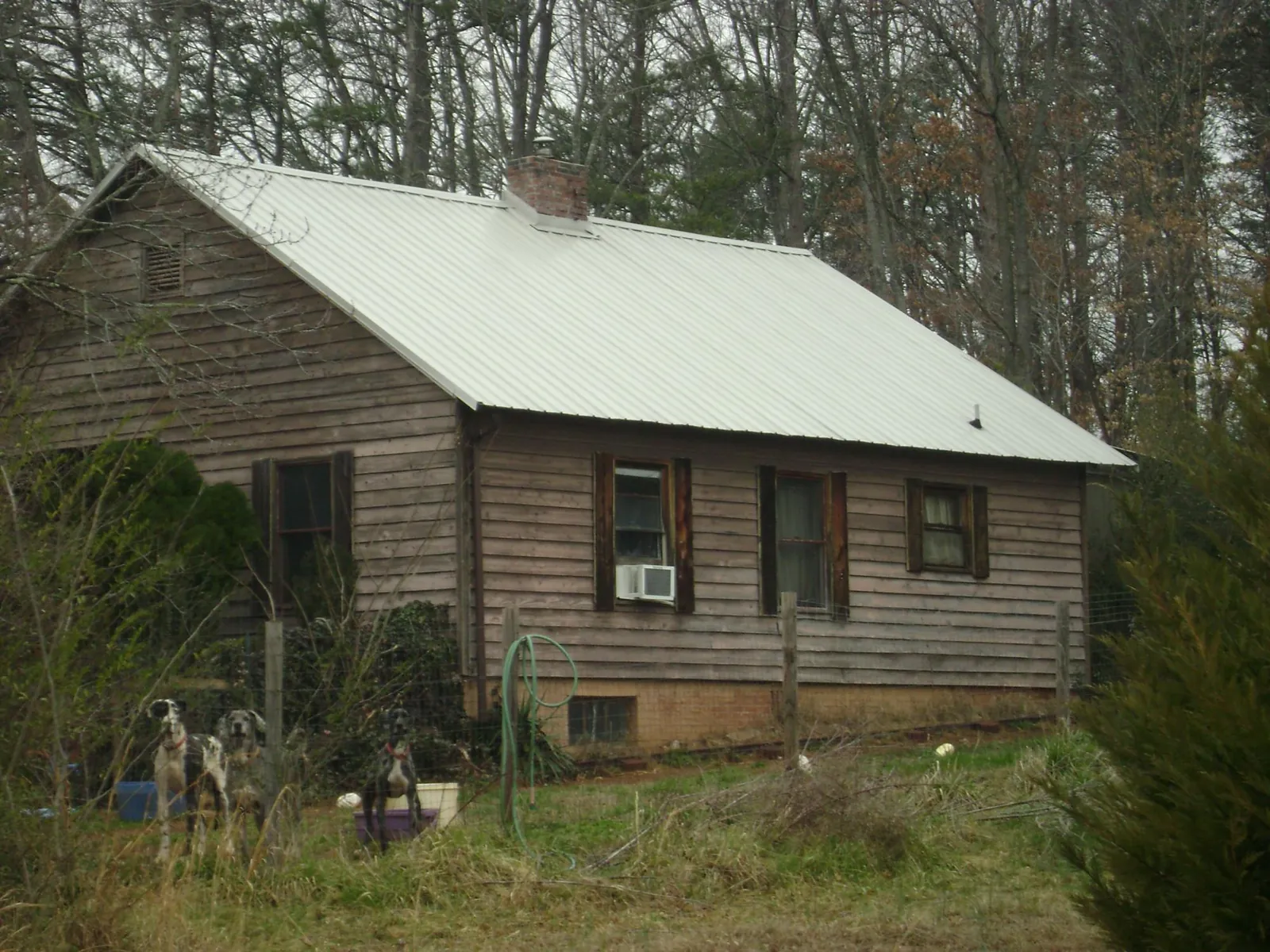 White metal roof on an old wood sided farmhouse, from a Metal Roof Installation job in Oceanside